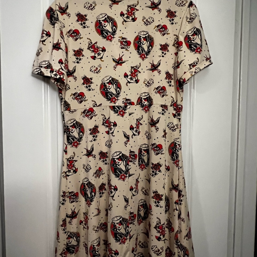 This beautiful WOMENS brand new 2xl Sourpuss dress. It's soft stretchy material.